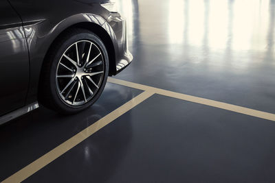 Close up of modern car in parking lot, anti slip coating floor for safety