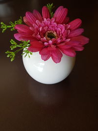 High angle view of pink flower vase on table