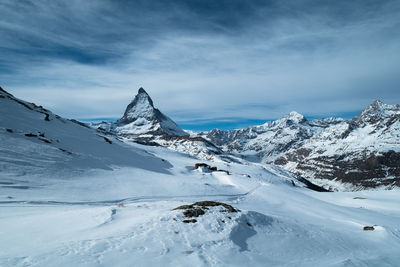 Scenic view of snowcapped mountains against sky