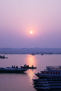 Boat in sea at sunset