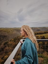 Side view of woman against sky