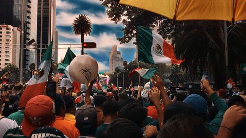 People on street against buildings in city