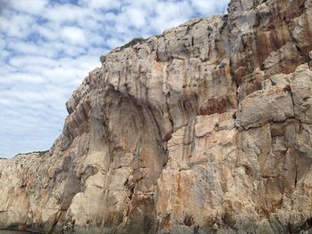 Low angle view of rock formation against sky