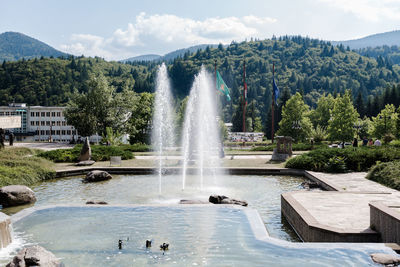 Scenic view of waterfall against sky