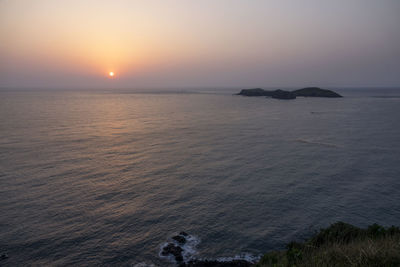 Scenic view of sea against clear sky during sunset