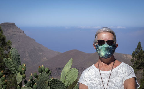 Portrait of woman wearing sunglasses against sky