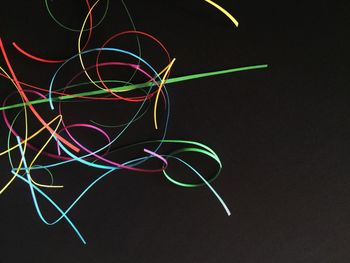 Close-up of illuminated lights over black background