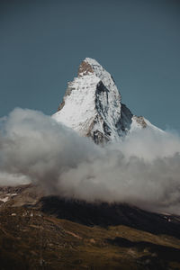 Low angle view of snowcapped mountain against sky