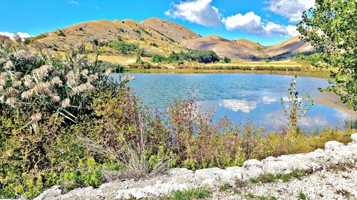Scenic view of lake and mountains against sky