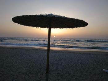 Scenic view of beach against sky during sunset