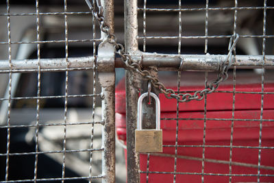 Close-up of padlock on metal fence