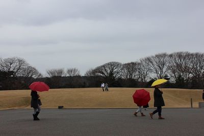 Rear view of two people walking in winter