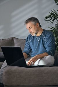 Young man using laptop at home