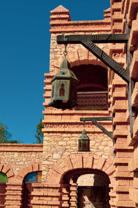 Low angle view of old building against blue sky