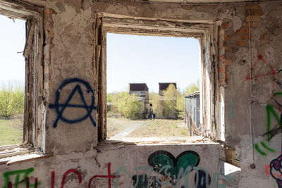 Graffiti on old building against clear sky