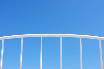 Low angle view of metallic structure against blue sky