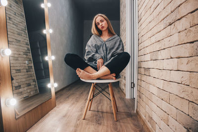 Portrait of woman sitting on chair