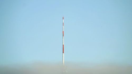 Low angle view of windmill against clear blue sky