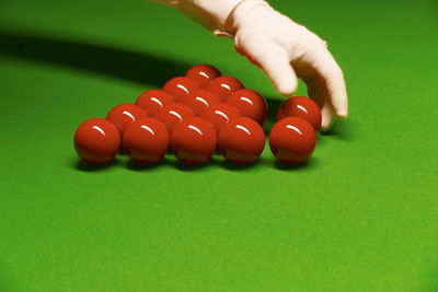 Cropped hand adjusting balls on pool table