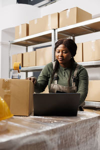 Portrait of young woman using laptop on table