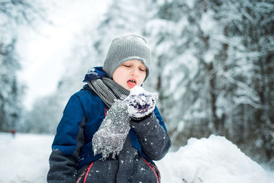 Portrait of boy wearing hat during winter