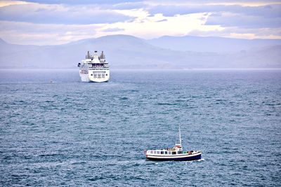 Boat sailing on sea against sky