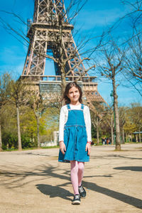 Young woman standing on footpath