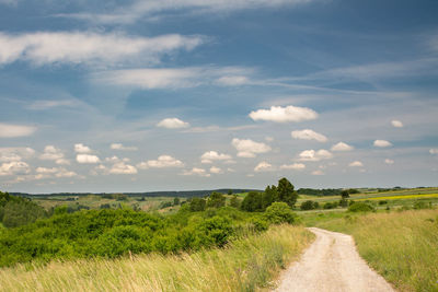 Empty road along countryside landscape