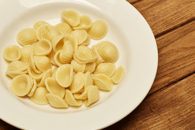 High angle view of pasta in plate on wooden table