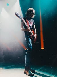 Full length of a man holding guitar