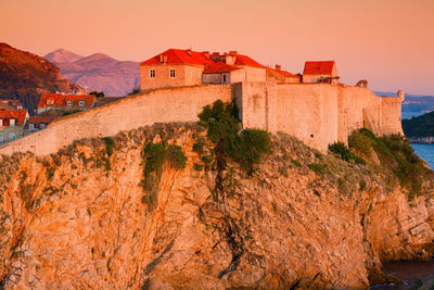 Historic building against sky during sunset