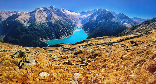 Scenic view of snowcapped mountains against blue sky