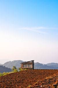 Built structure on field against sky