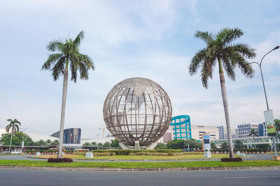 Palm trees with buildings in background