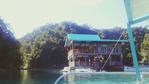 Built structure by lake against clear sky