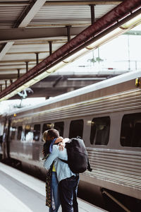 Rear view of people on train at railroad station