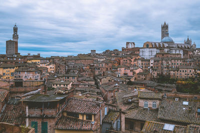 Ancient buildings in city against sky