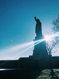 Low angle view of statue against blue sky