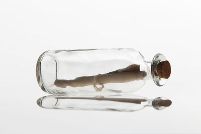 Close-up of cork in bottle on white background