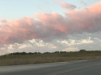 Scenic view of field against sky at sunset