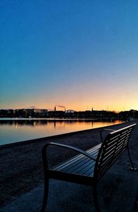 Scenic view of lake against clear sky at sunset