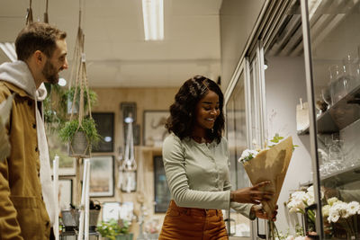 Woman buying flowers in shop