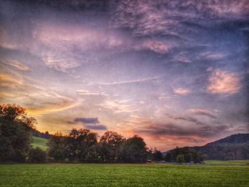 Scenic view of field against sky during sunset