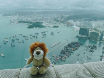 Close-up of small toy on sea against sky