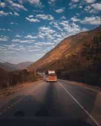 Cars on road against sky