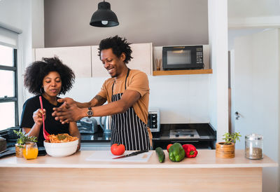 Couple preparing food in kitchen at home