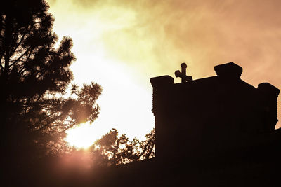 Low angle view of silhouette trees against sky during sunset