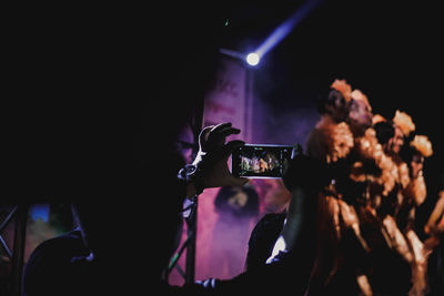 People enjoying music concert at night