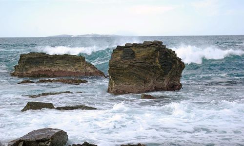 Scenic view of sea and rock formation against sky