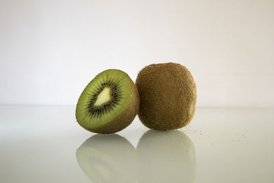 Close-up of fruits on table against white background